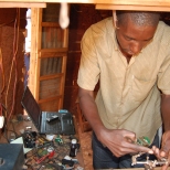 Oscar Baravuma, 38, works on cell phones and computers inside a refugee camp in Tanzania. He fled his native country of Burundi in 1995 after he said his village was burned, people were hacked to death and neighborhoods were divided according to ethnicity.